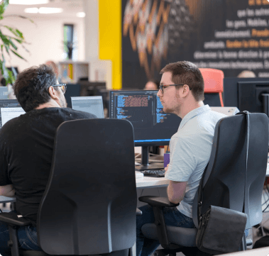 Looking Over Shoulders of Coworkers Working on Computers -FundedNext