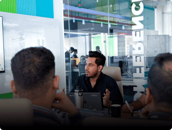 FundedNext Employee Speaking at Meeting in Conference Room