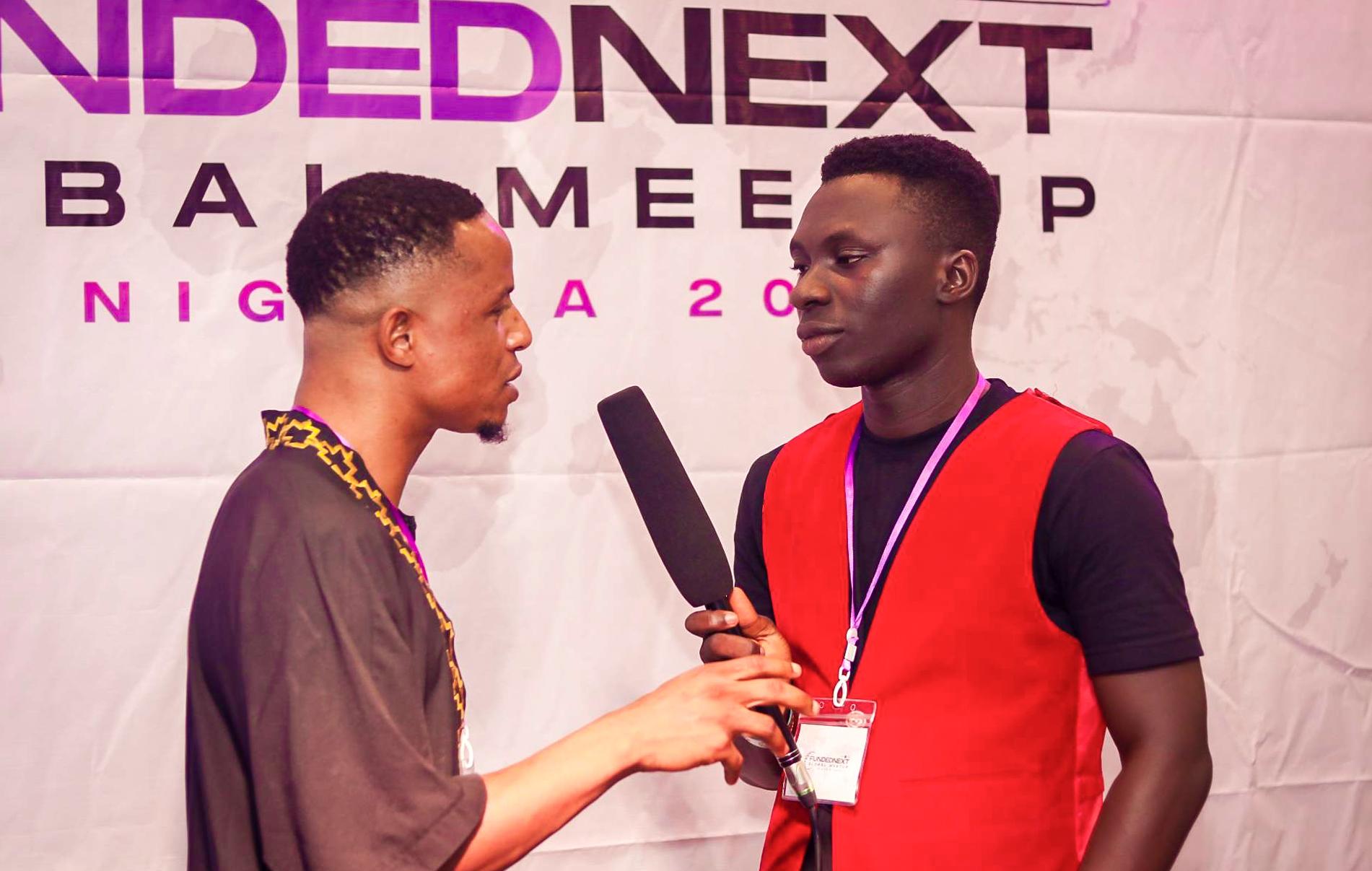 FundedNext Trader Bein Interviewed Speaking into Microphone