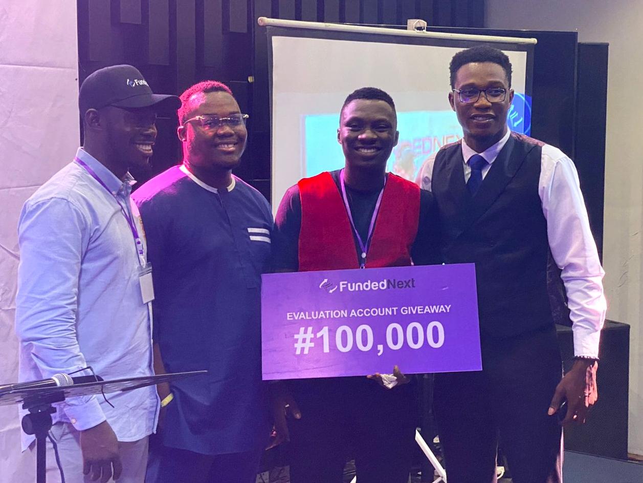 Trader Holding $100,000 Check Prize from FundedNext Challenge